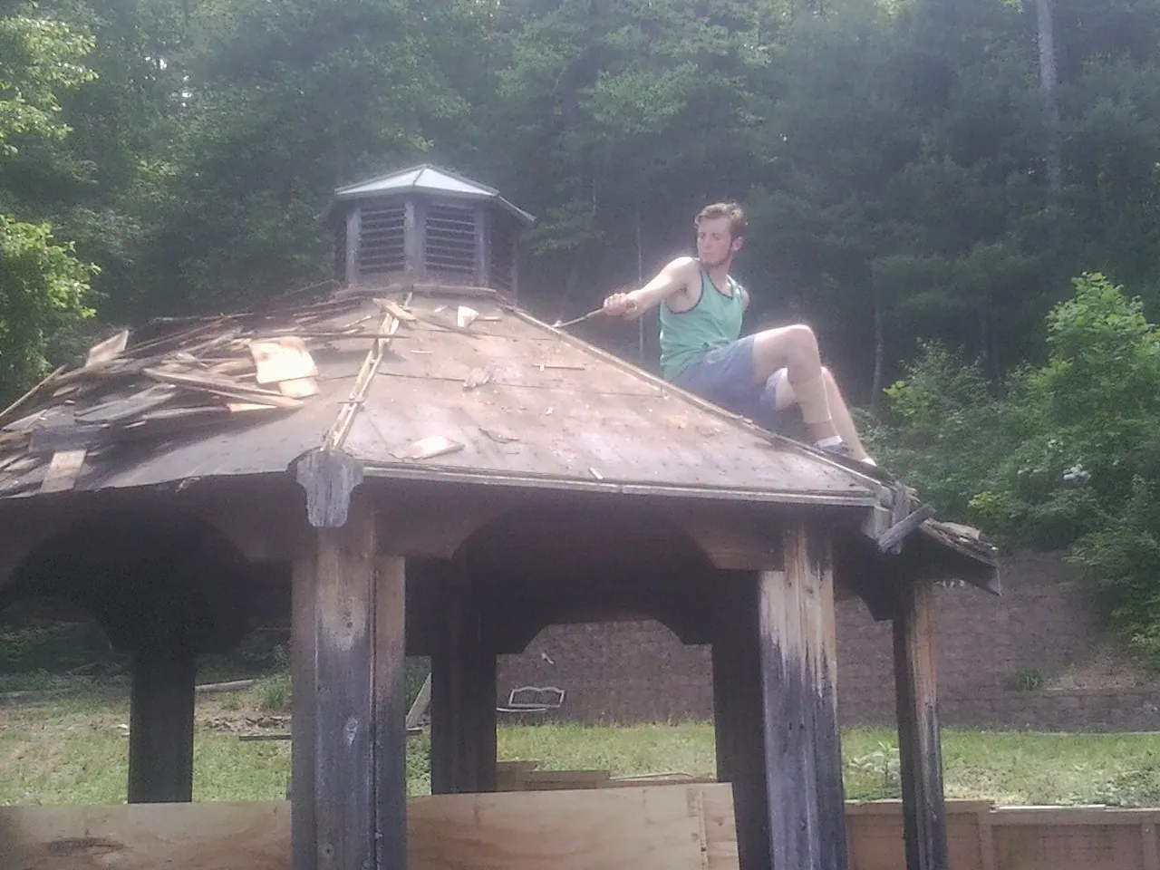 Tearing the old roof off a wooden gazebo before new shakes in Barnegat Light