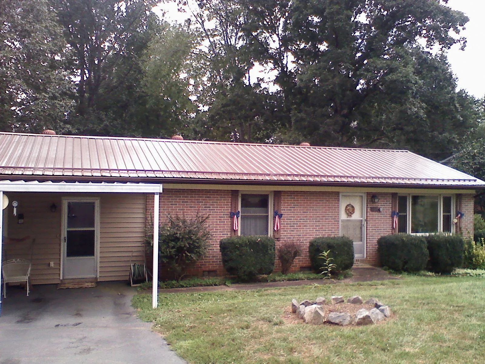 Bronze metal roof and carport on a brick ranch home — Roof Repair work by our crew in Barnegat Light